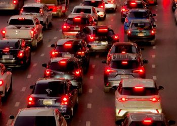 Heavy traffic jam in downtown Bangkok at twilight with numerous cars